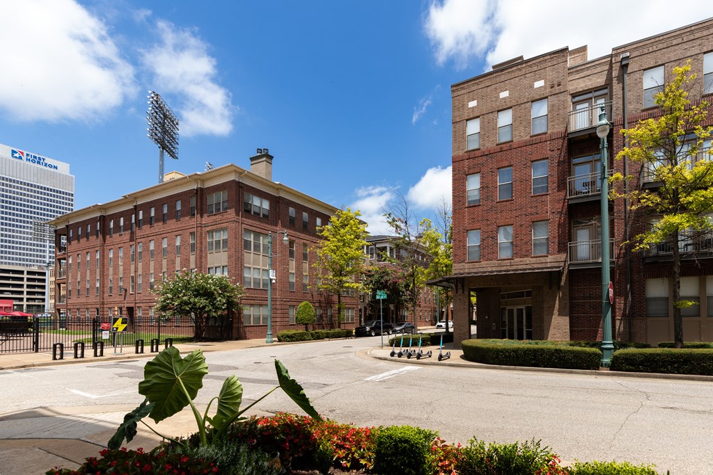 a large red brick building on the corner of a street