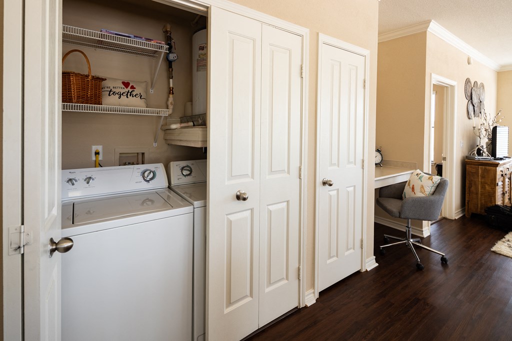 a kitchen with a washer and dryer and a door to the laundry room