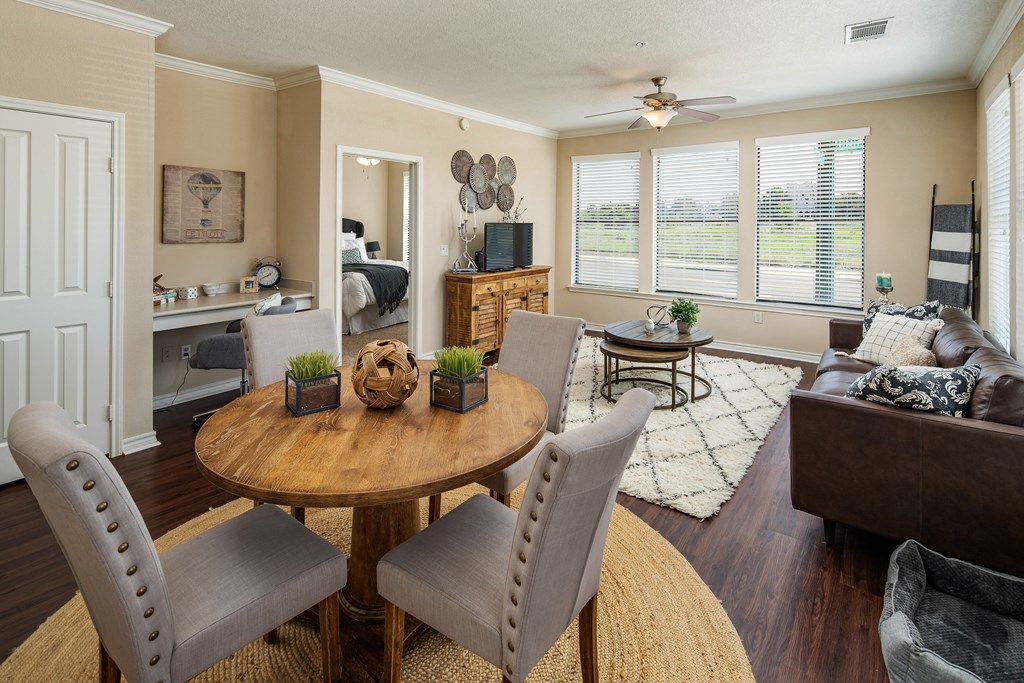 an open living room and dining room with a table and chairs