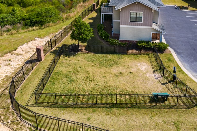 an aerial view of a house in a fenced in yard