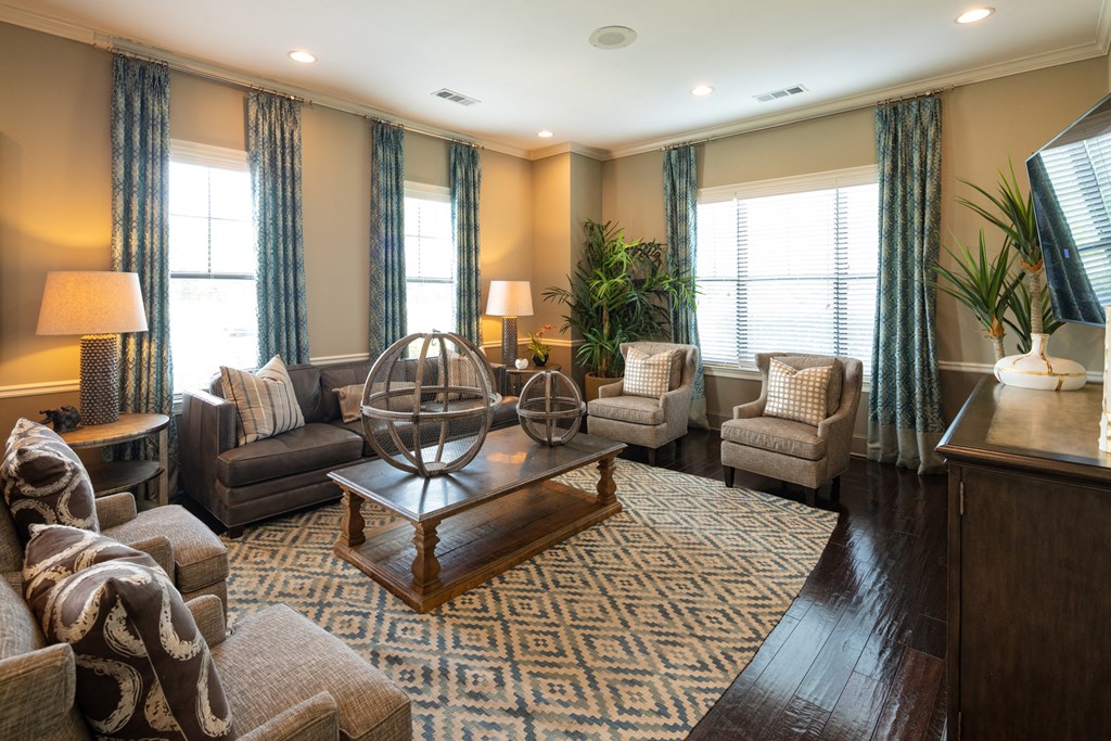 a living room with couches and chairs and a table
