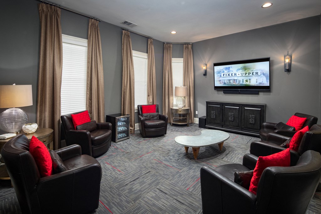 a living room with couches and chairs and a television