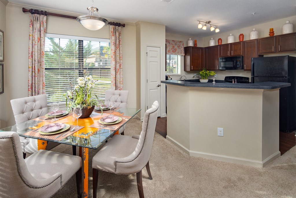 a kitchen and dining room with a table and chairs