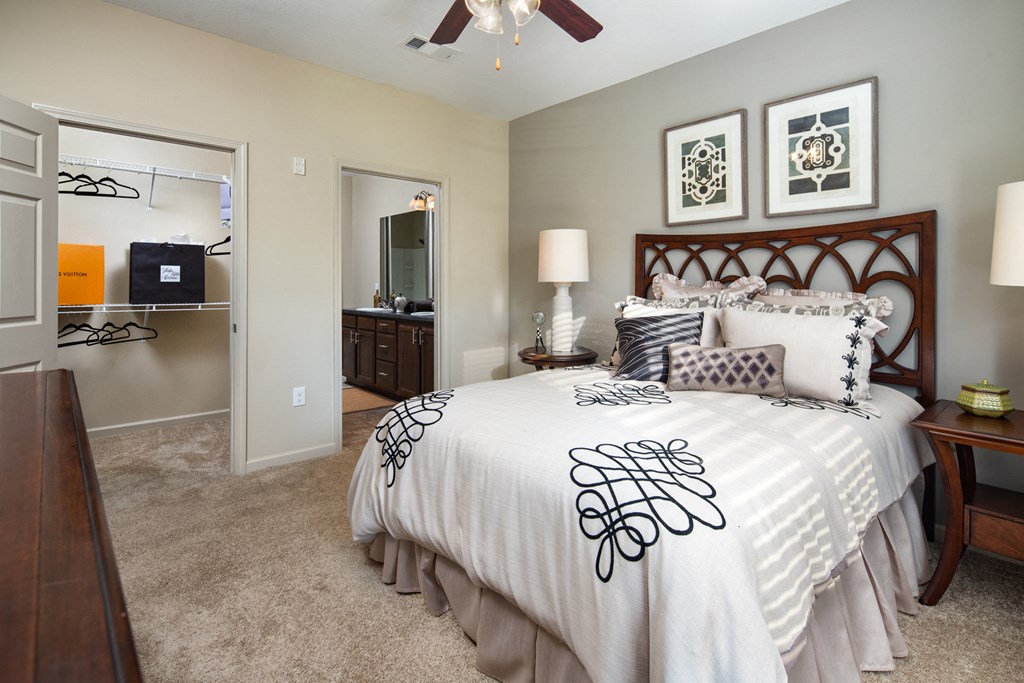 a bedroom with a large bed and a ceiling fan