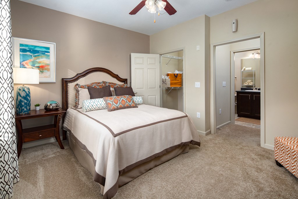 a bedroom with a bed and a ceiling fan