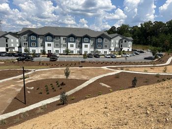 A large building with a parking lot in front of it. at Fairview Springs in Covington, GA, 30016