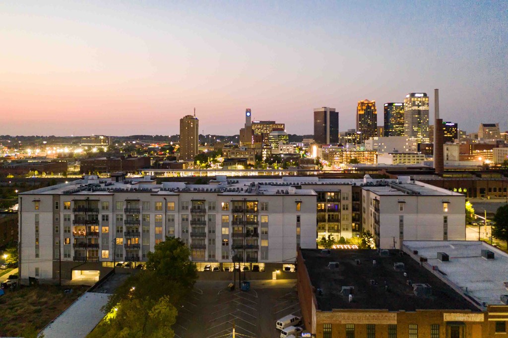 a view of the city at night from the roof of a building