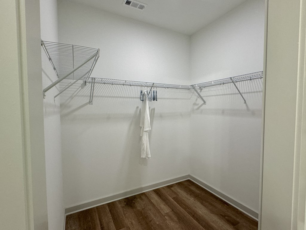 A white closet with a white towel hanging on a rod at Allier Foley, Foley, AL 36535