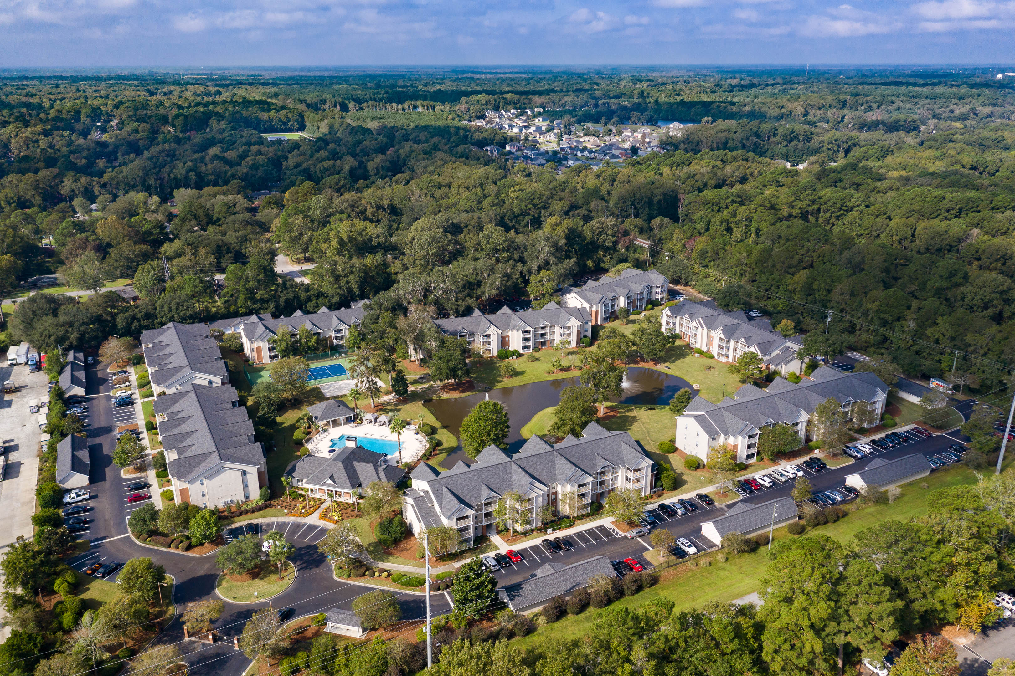 a aerial view of a neighborhood with houses and a pool
