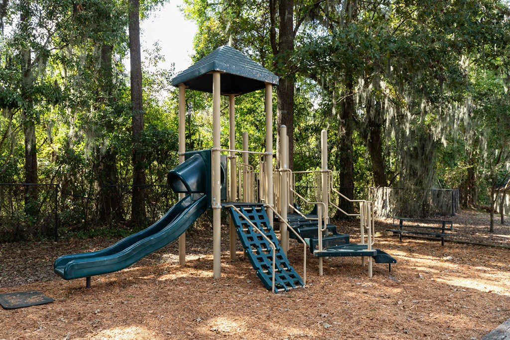 a playground with a slide and a play set