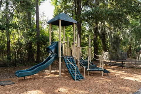 a playground with a slide and a play set