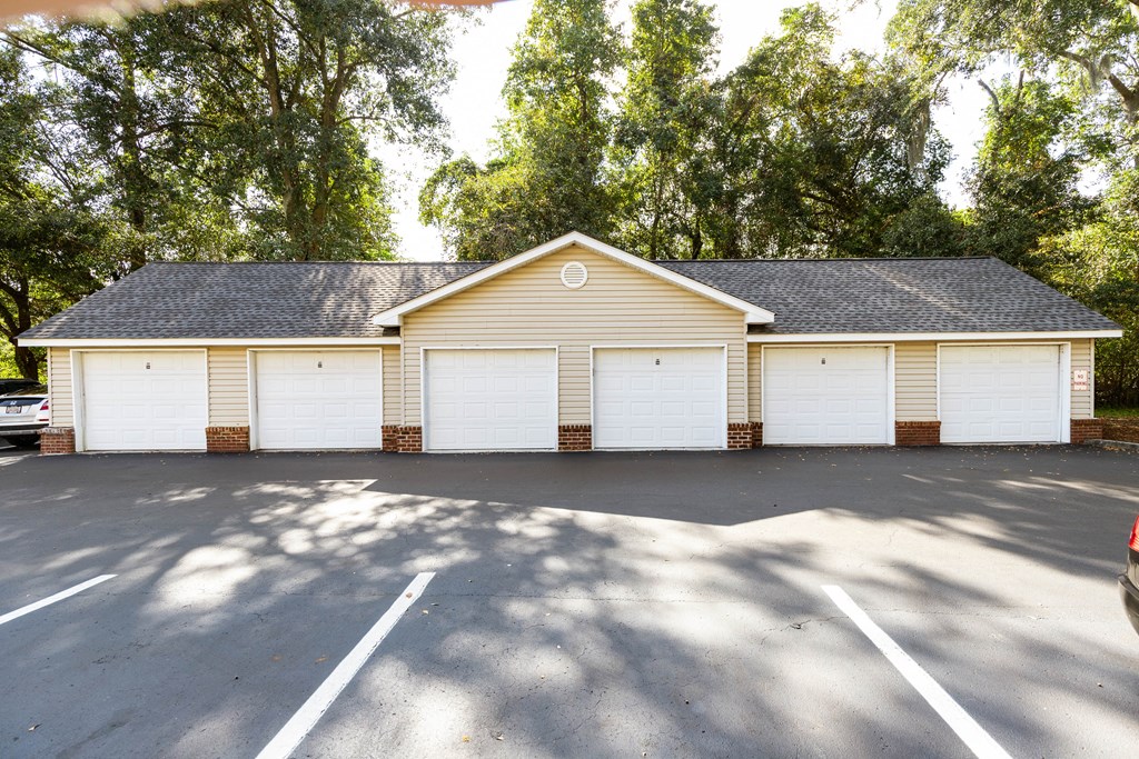 a white garage with white doors in a parking lot