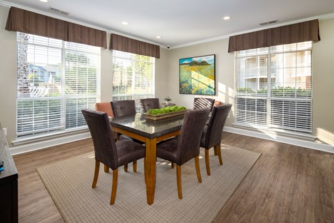 a dining room with large windows and a table with chairs