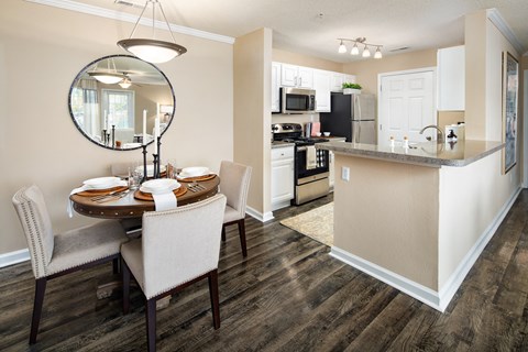 an open kitchen and dining area with a table and chairs and a kitchen counter top