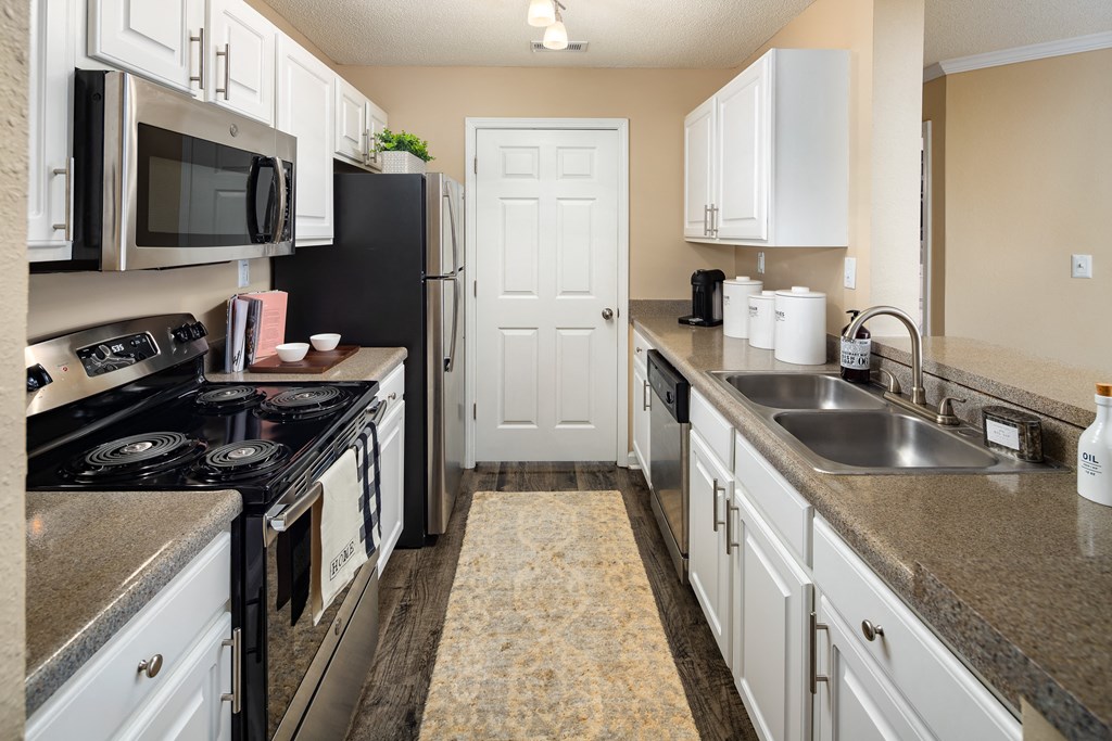 full kitchen with granite countertops and stainless steel appliances at the preserve at greatstone