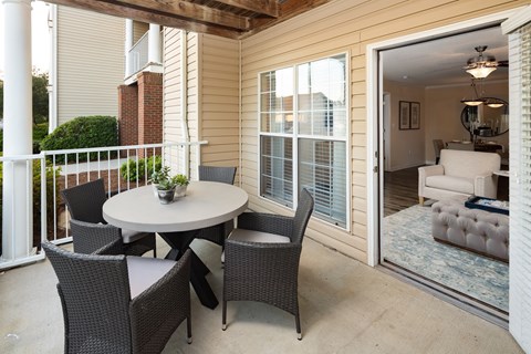 a patio with a table and chairs and a sliding glass door