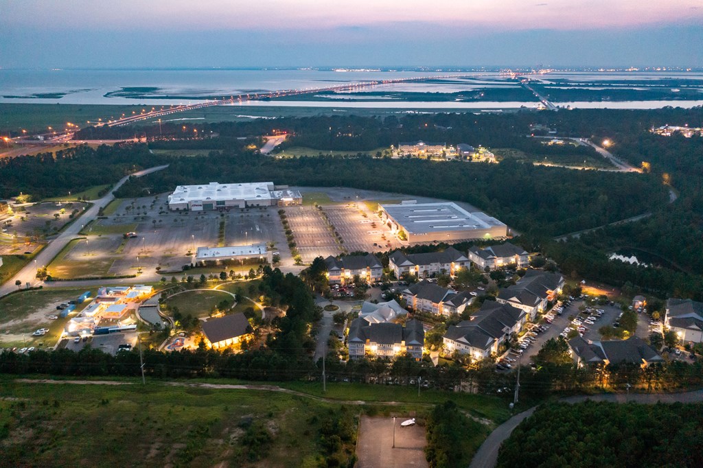 an aerial view of an airport at night with lights on the buildings