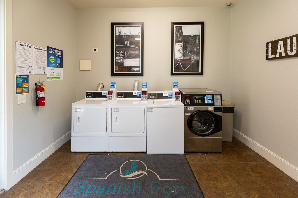 a laundry room with a washing machine and a washer and dryer