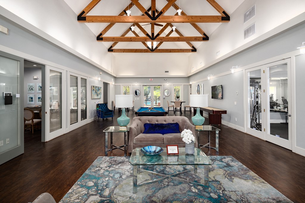 a living room with a couch and a glass coffee table