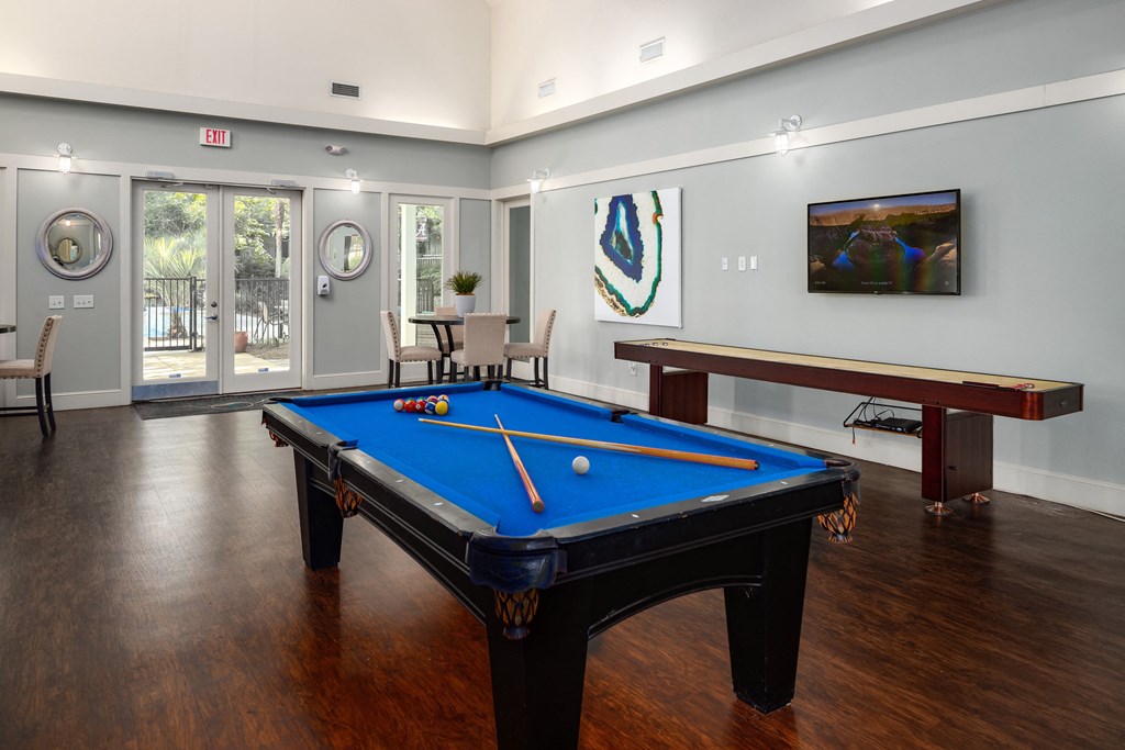 a games room with a pool table and a billiard