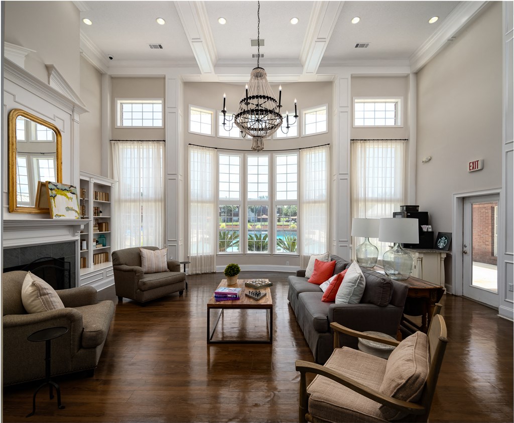 a large living room with couches and chairs and a fireplace