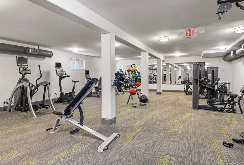 a gym with treadmills and other exercise equipment in a building