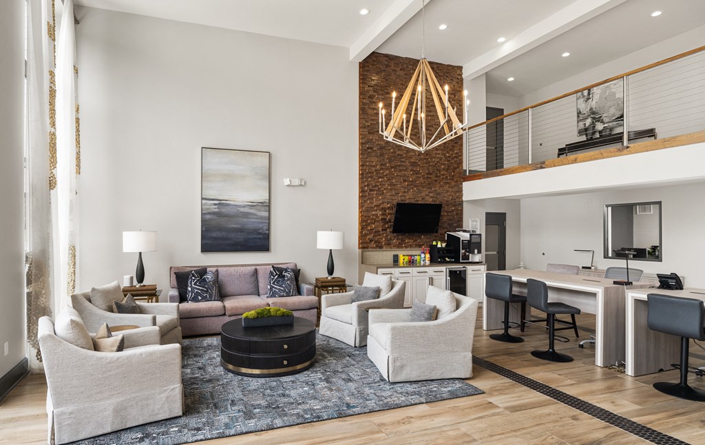 a living room with couches and chairs and a dining room table and a kitchen