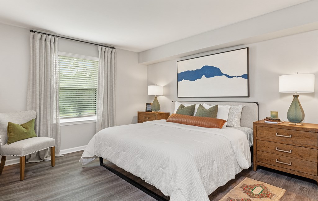 a bedroom with a large bed and a window