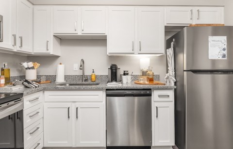 a kitchen with stainless steel appliances and white cabinets