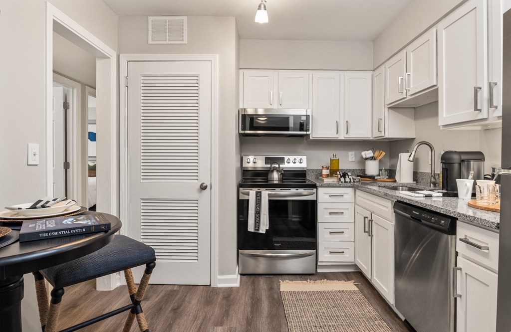 a kitchen with stainless steel appliances and white cabinets