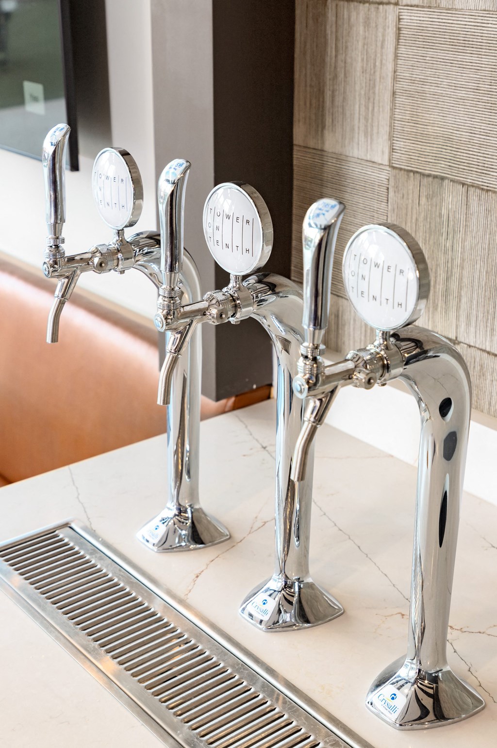 a pair of chrome faucets in a bathroom sink