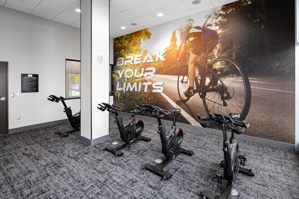 a wall mural in an office gym with a cyclist on a bike and the words break your