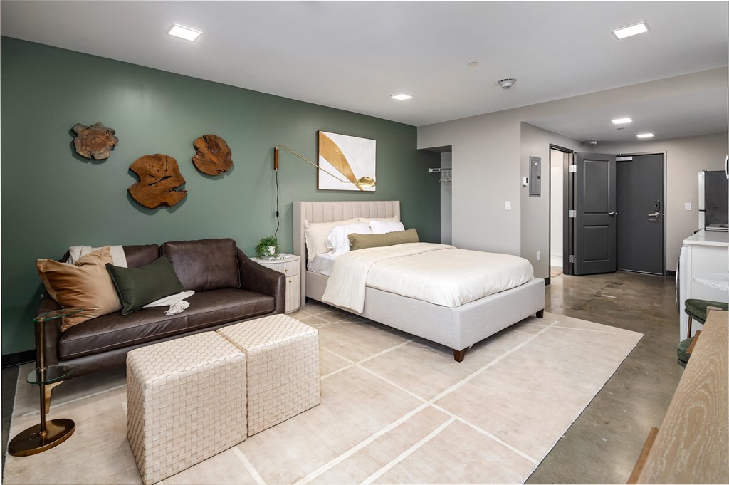 a bedroom with a bed and a couch in a room