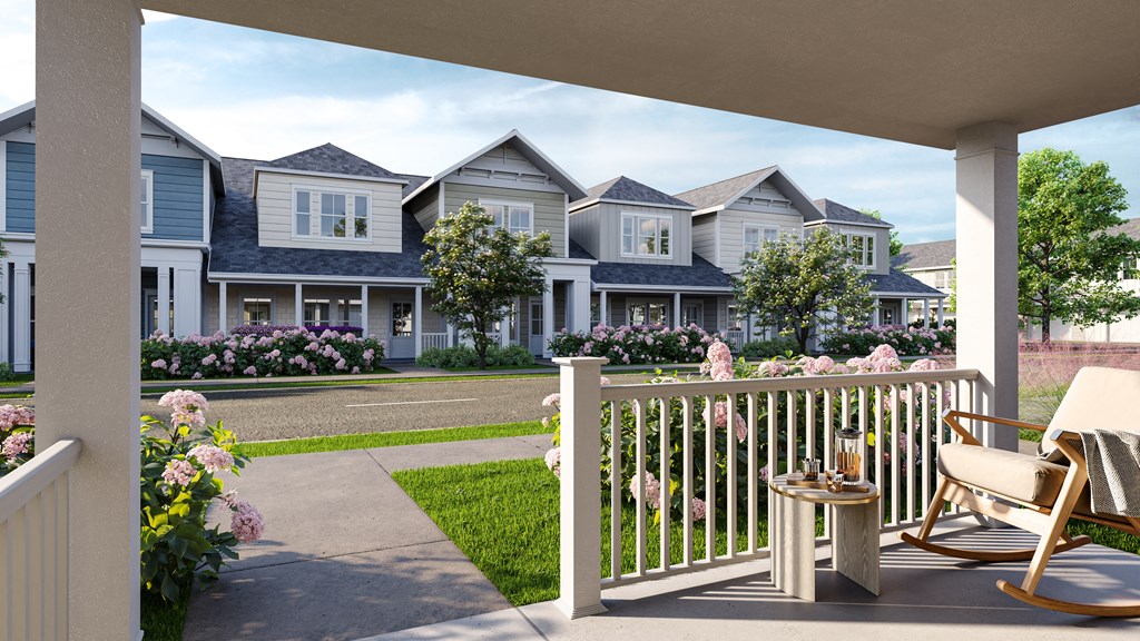 a patio with chairs and a table on a porch in front of houses at Allier Foley, Foley, AL 36535
