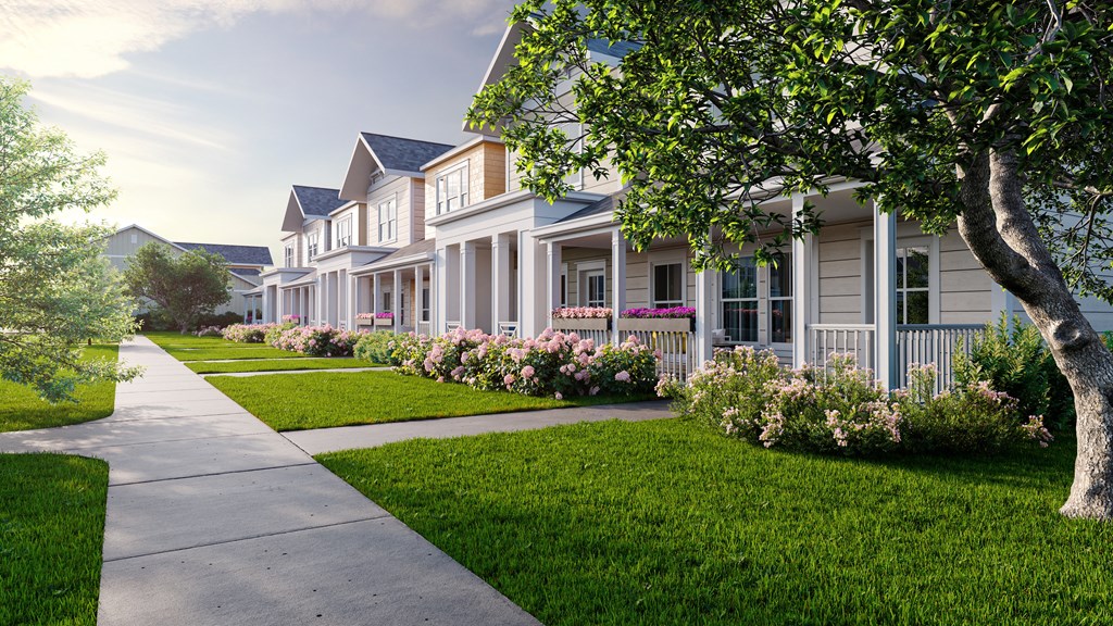 a row of houses with flowers in front of them on a sidewalk at Allier Foley, Foley, AL 36535
