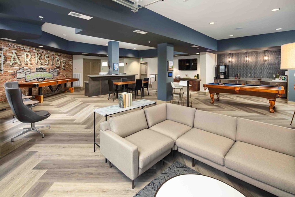 a lounge room with a pool table and a couch