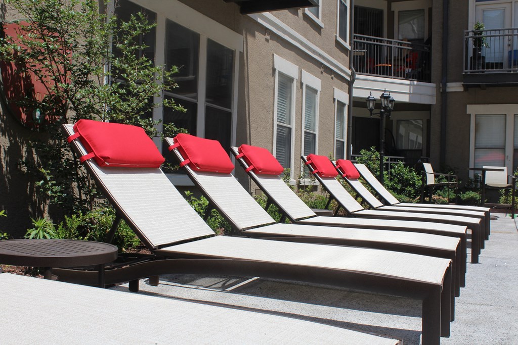 a row of beach chairs in front of an apartment building