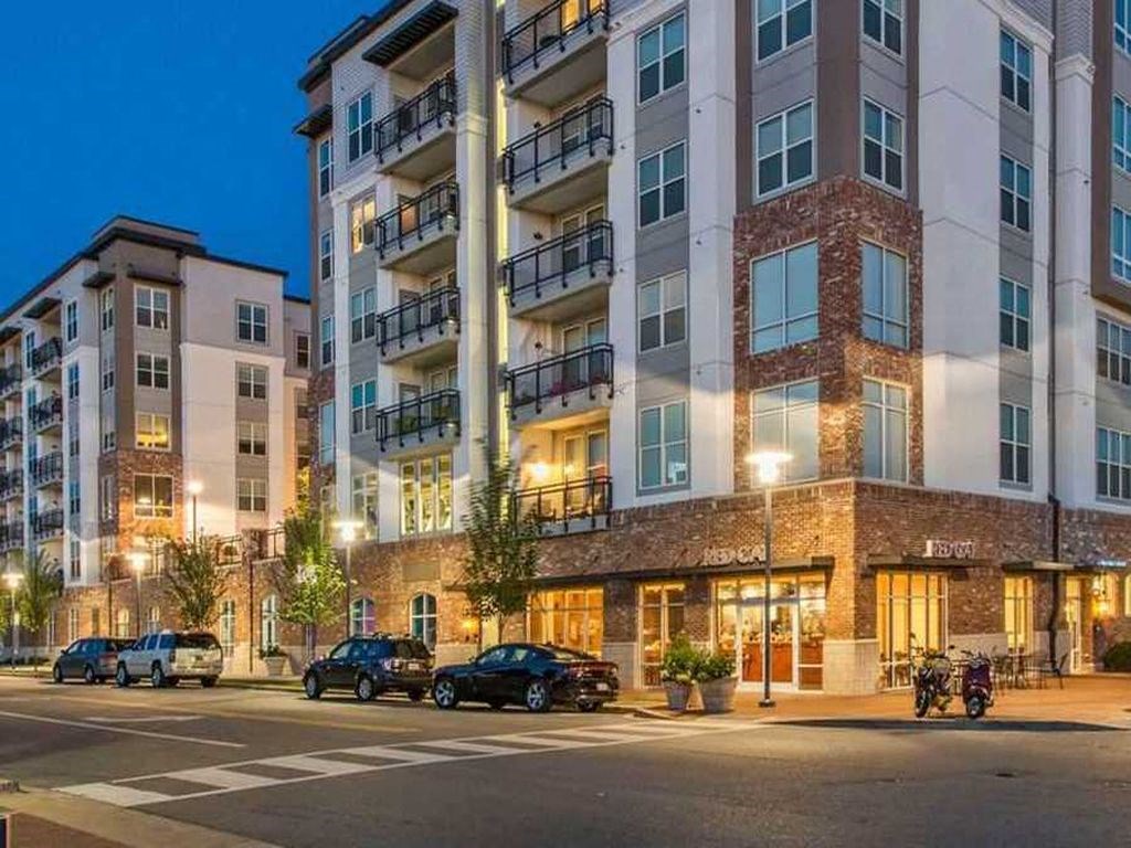 an apartment building on a city street at night