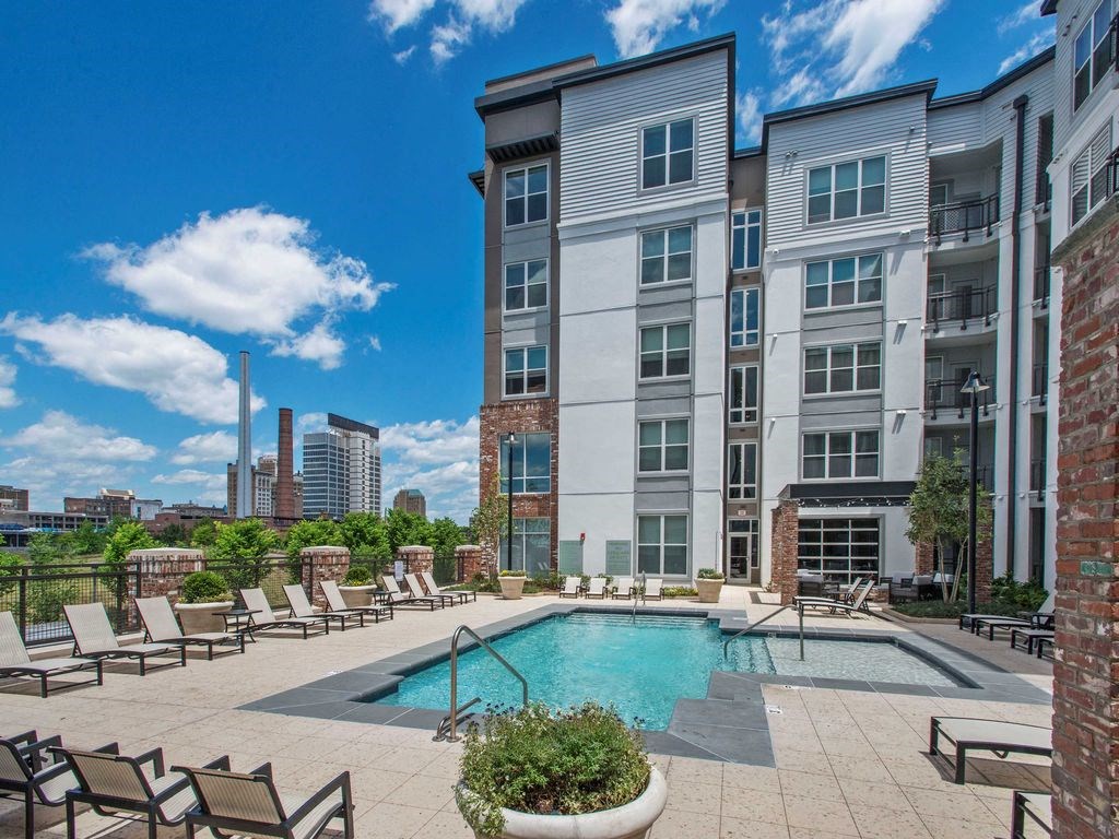 our apartments offer a swimming pool with a city in the background