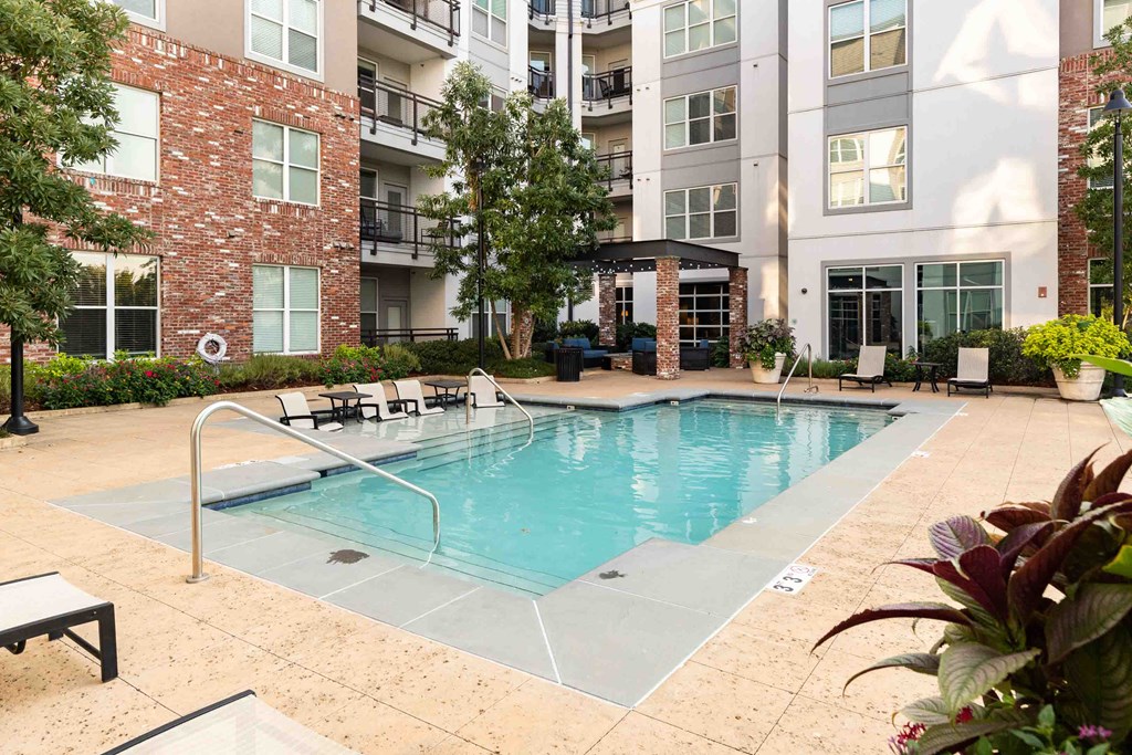 a swimming pool in front of an apartment building