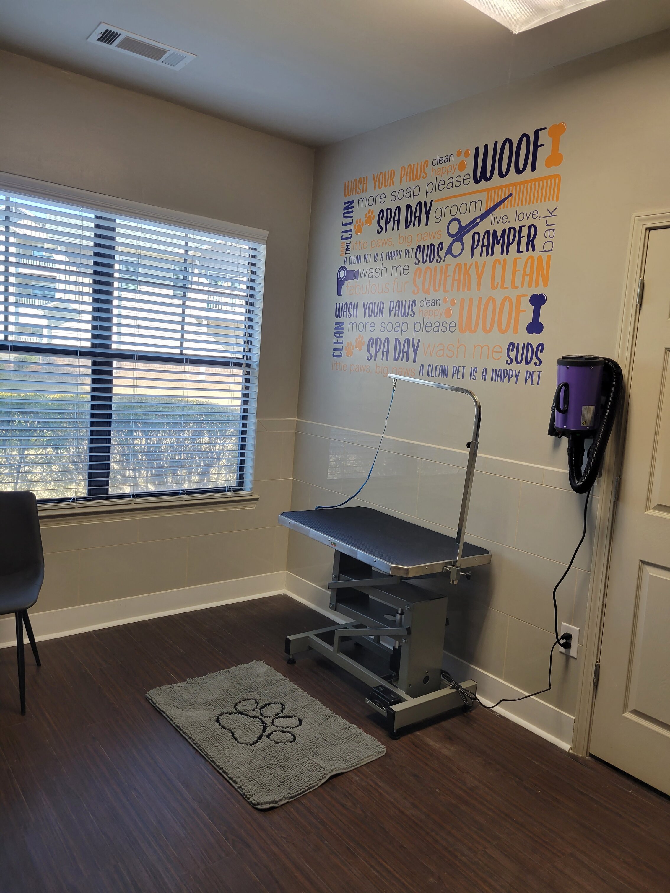 an exam room with a table and a chair in front of a window