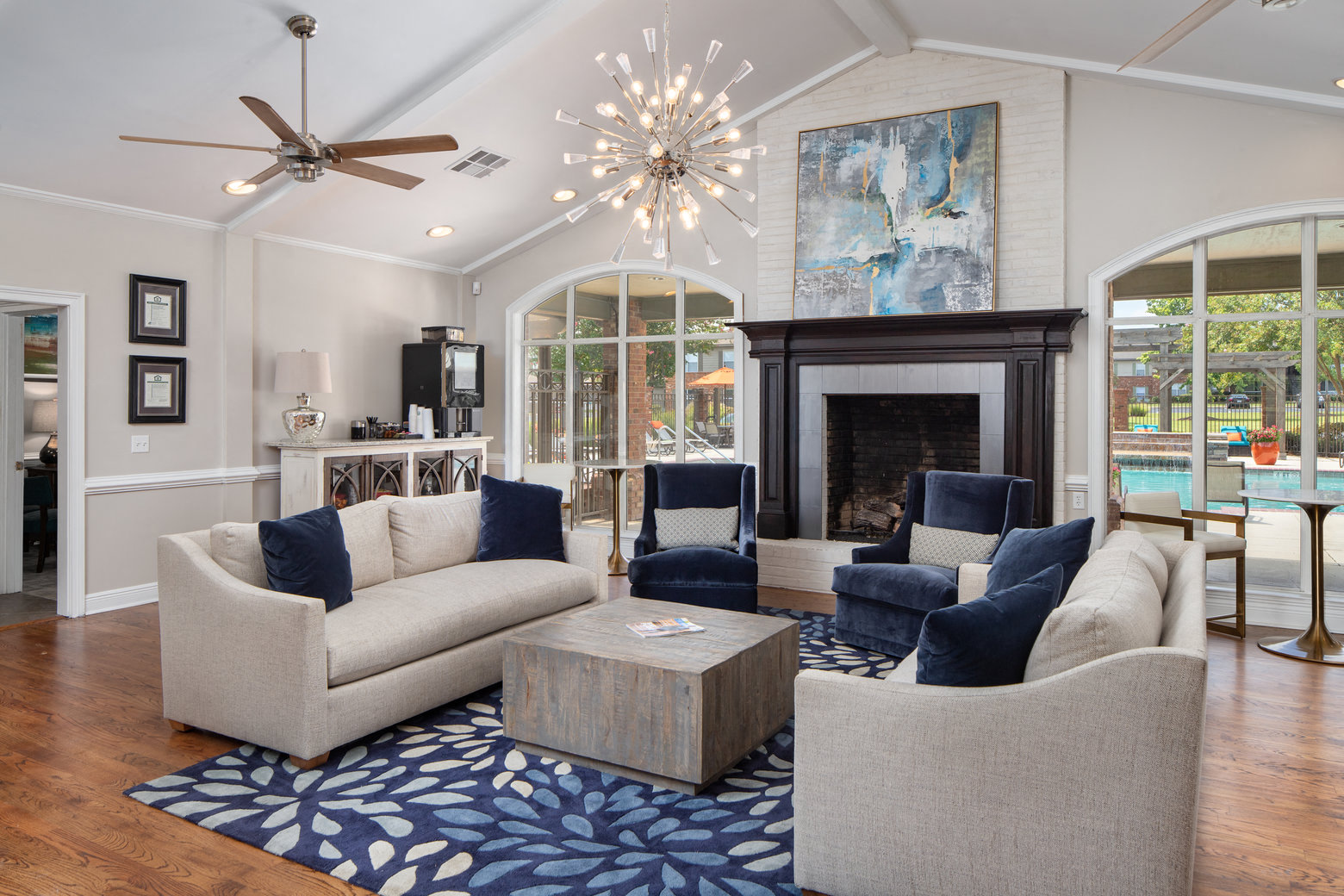 a living room with couches and chairs and a fireplace