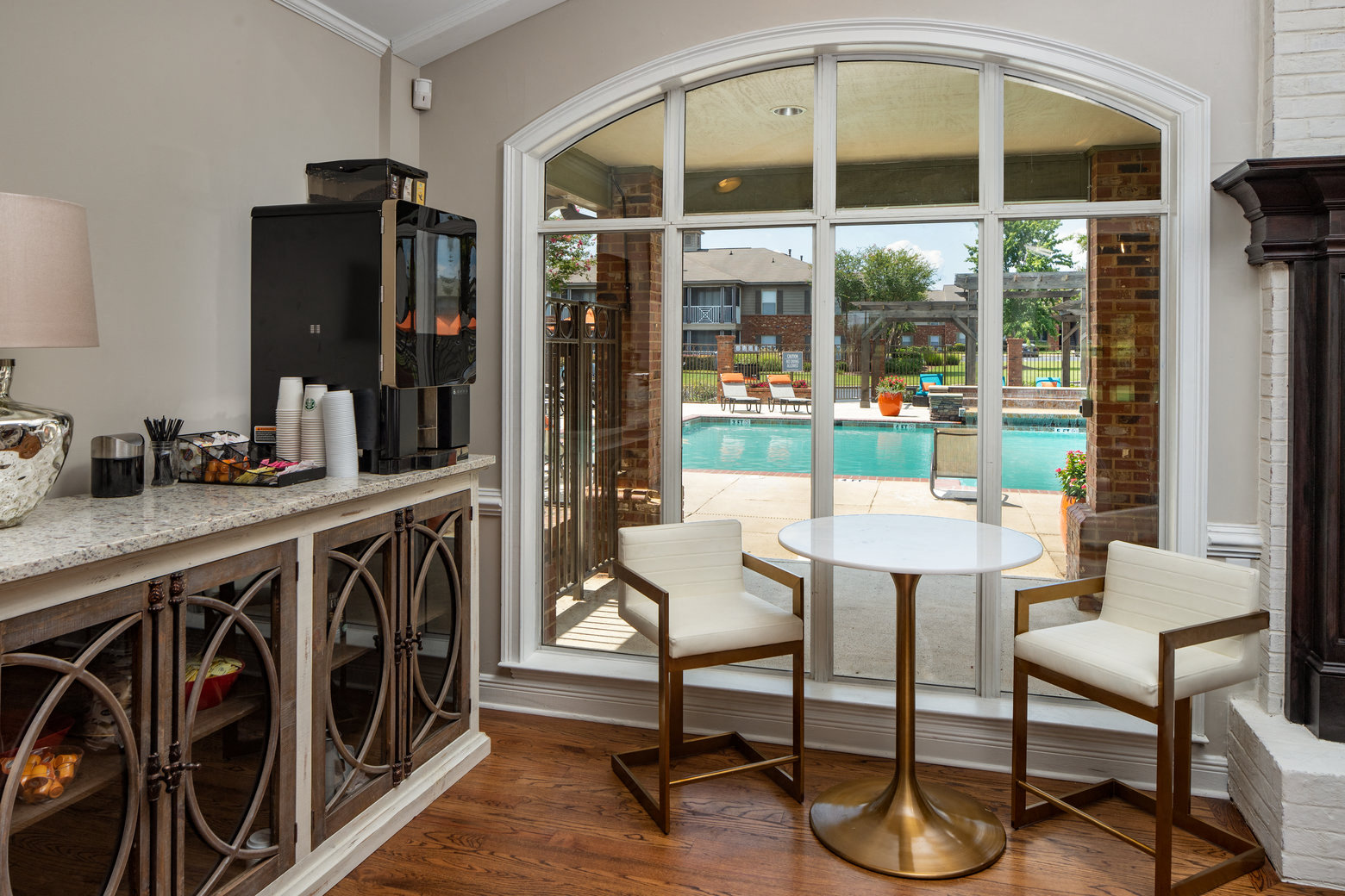 a living room with a table and chairs and a pool
