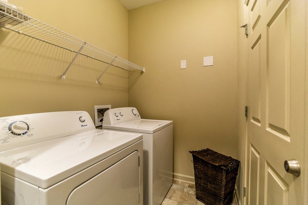 a laundry room with a washer and dryer and a closet