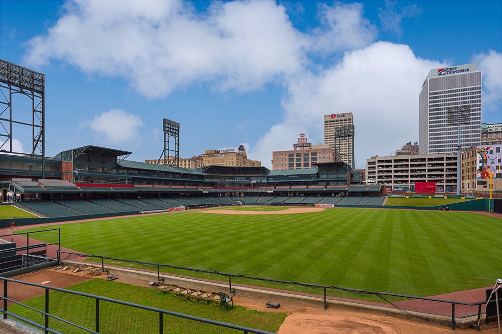 a view of a baseball stadium with a city in the background