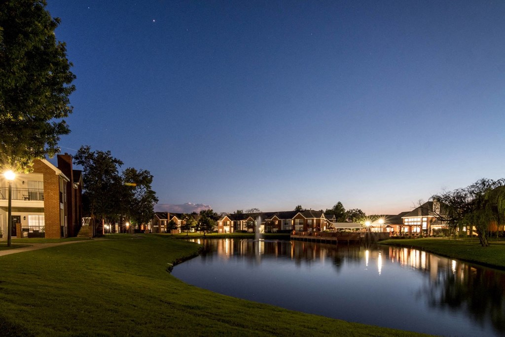 a lake with houses around it at night