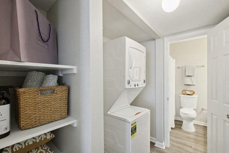 a laundry room with a toilet and a washer and dryer