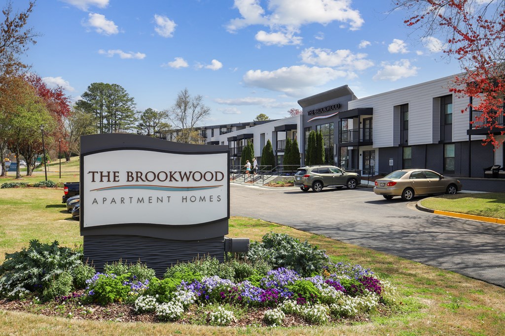 the brookwood apartment homes sign in front of a parking lot