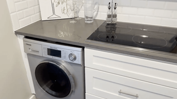 a small laundry room with a sink and a washing machine