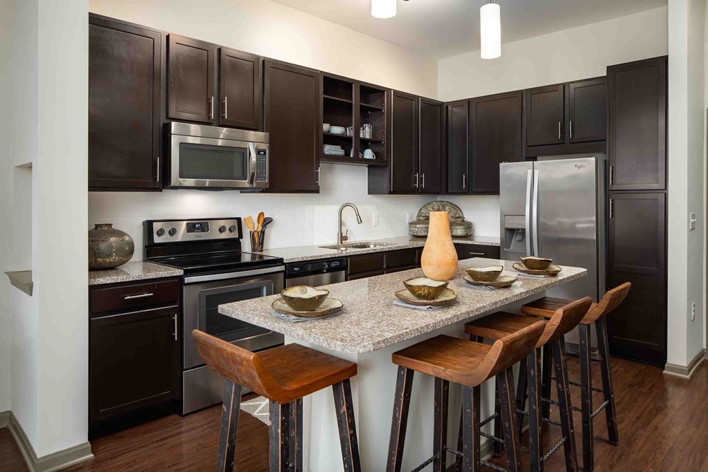 a kitchen with stainless steel appliances and a granite counter top